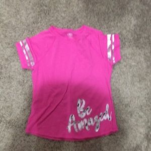 Pink shirt says be amazed
